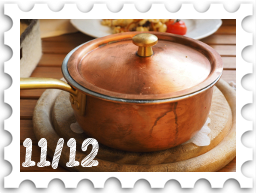 November/December 2024Potluck SWG challenge stamp - a copper saucepot with lid on a round wooden trivet